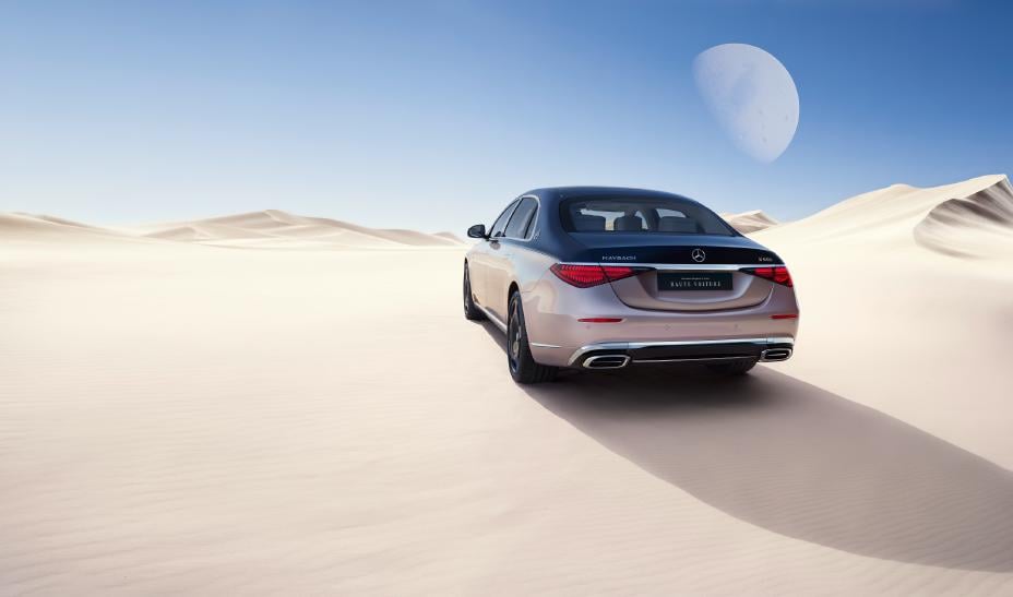 Mercedes-Maybach S 680 Haute Voiture, a nautical-blue over rose-gold two-tone S-Class in a desert dune setting, rear three-quarter view